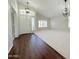 Bright open-concept living room with vaulted ceilings, modern lighting, and dual flooring at 1679 E Oakland St, Gilbert, AZ 85295