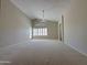 Living room with carpeted floor, door to back yard, and doorway to other rooms at 1679 E Oakland St, Gilbert, AZ 85295