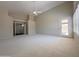 Bright living room with carpet, ceiling fan, and doors to the outside and to the house at 1679 E Oakland St, Gilbert, AZ 85295