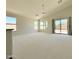Spacious living room with large windows, sliding glass door, and vaulted ceiling with ceiling fan at 1679 E Oakland St, Gilbert, AZ 85295