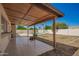 View of the backyard with a covered patio and tile flooring looking towards the fenced in pool at 17244 N 36Th Ln, Glendale, AZ 85308