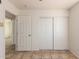 Bedroom featuring tile flooring and a closet with double doors for storage space at 17244 N 36Th Ln, Glendale, AZ 85308