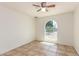 Cozy bedroom featuring tile floors and a unique arched window offering natural light at 17244 N 36Th Ln, Glendale, AZ 85308