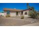 Front exterior of tan home with rock landscaping, rounded windows and brown trim at 17244 N 36Th Ln, Glendale, AZ 85308