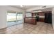 Bright kitchen with dark wood cabinets, bar seating, and slider to the backyard at 17244 N 36Th Ln, Glendale, AZ 85308