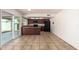 Well-lit kitchen with black appliances, wood cabinets, breakfast bar, and sliding doors to the back at 17244 N 36Th Ln, Glendale, AZ 85308