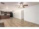 Open-concept living area with tile flooring, kitchen view, and a ceiling fan at 17244 N 36Th Ln, Glendale, AZ 85308