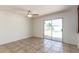 Open living space with neutral tile flooring and sliding glass doors leading to the backyard pool at 17244 N 36Th Ln, Glendale, AZ 85308