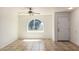 Open living space with ceramic tile flooring, ceiling fan, and arched window at 17244 N 36Th Ln, Glendale, AZ 85308