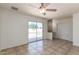 Neutral living space with tile flooring, ceiling fan, and view of the pool at 17244 N 36Th Ln, Glendale, AZ 85308