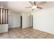 Bright living area with tile flooring, fan, and open closet storage at 17244 N 36Th Ln, Glendale, AZ 85308