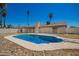 View of the pool, surrounded by palm trees and a white fence, offers a private oasis at 17244 N 36Th Ln, Glendale, AZ 85308