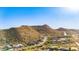 Sweeping aerial of a desert community nestled against a hillside offering breathtaking views and a serene living environment at 1753 N Berrett --, Mesa, AZ 85207