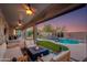 Inviting outdoor living space with a fire pit, pool, and lush landscaping for relaxation and entertainment at 1753 N Berrett --, Mesa, AZ 85207