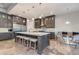 Spacious kitchen featuring custom cabinets, a large marble island with barstool seating, and stainless steel appliances at 1753 N Berrett --, Mesa, AZ 85207