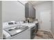 Bright laundry room with modern appliances, storage cabinets, and a folding counter for convenience at 1753 N Berrett --, Mesa, AZ 85207