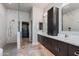 Luxurious bathroom featuring marble surfaces, dual sinks, and a glass-enclosed shower at 1753 N Berrett --, Mesa, AZ 85207