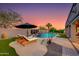 Backyard pool features lounge chairs and waterfall, set against a backdrop of desert landscaping and a tranquil atmosphere at 1753 N Berrett --, Mesa, AZ 85207