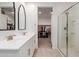Bright bathroom with double sinks, shower, and walk-in closet at 17864 W Fetlock Trl, Surprise, AZ 85387