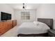 Cozy bedroom with a ceiling fan, neutral carpet, and a view of the window at 17864 W Fetlock Trl, Surprise, AZ 85387