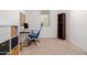 Bright bedroom, set up as a home office with a sleek desk, natural light, and ample storage at 17864 W Fetlock Trl, Surprise, AZ 85387