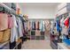 Spacious walk-in closet with ample storage and organization solutions for clothing and accessories at 17864 W Fetlock Trl, Surprise, AZ 85387