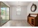 Bright dining room with sliding glass door, modern chandelier and tiled floors at 17864 W Fetlock Trl, Surprise, AZ 85387