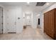 Open entryway with tile flooring, coat rack, and storage in a well-lit space at 17864 W Fetlock Trl, Surprise, AZ 85387