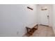 The entryway has tile flooring, a coat rack, and a bench at 17864 W Fetlock Trl, Surprise, AZ 85387