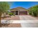 Charming single-story home with a two car garage, desert landscaping, and inviting curb appeal at 17864 W Fetlock Trl, Surprise, AZ 85387