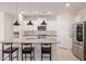 Bright kitchen with stainless steel appliances, granite counters and island with bar seating at 17864 W Fetlock Trl, Surprise, AZ 85387