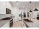 Gourmet kitchen with stainless steel appliances, granite counters, and a farmhouse sink at 17864 W Fetlock Trl, Surprise, AZ 85387
