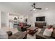 Open-concept living room connected to a modern kitchen, ideal for gatherings and relaxation at 17864 W Fetlock Trl, Surprise, AZ 85387