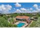 Scenic aerial view of the property featuring a pool, patio, and lush greenery with mountain views at 18132 E Vencino St, Gilbert, AZ 85298
