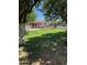 Expansive backyard with lush green grass, mature trees and plenty of space for outdoor activities at 18132 E Vencino St, Gilbert, AZ 85298