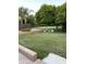 Expansive backyard features lush green grass and mature orange tree, perfect for outdoor activities at 18132 E Vencino St, Gilbert, AZ 85298