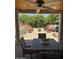 Inviting backyard features outdoor seating, a brick firepit, manicured shrubs and established trees at 18132 E Vencino St, Gilbert, AZ 85298