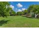 A large backyard with mature trees and well-maintained grass at 18132 E Vencino St, Gilbert, AZ 85298