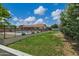 Large backyard featuring lush lawn, pool with black fencing and mature landscaping at 18132 E Vencino St, Gilbert, AZ 85298