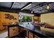 Relax with rustic bar, custom shelving, and fun foosball offering a perfect indoor-outdoor experience at 18132 E Vencino St, Gilbert, AZ 85298
