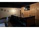 Stylish home bar featuring modern seating, a TV, and pendant lighting at 18132 E Vencino St, Gilbert, AZ 85298