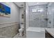 Bathroom features a tiled tub-shower combination with glass door and contemporary fixtures at 18132 E Vencino St, Gilbert, AZ 85298