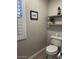 Well-lit powder room with decor, including a framed print, potted plant, and decorative lighthouse at 18132 E Vencino St, Gilbert, AZ 85298