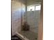 Modern shower with tiled walls and glass enclosure offers a clean and bright design at 18132 E Vencino St, Gilbert, AZ 85298