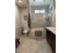 Updated bathroom features a tub and shower combination with glass enclosure and tiled walls at 18132 E Vencino St, Gilbert, AZ 85298