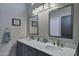 Bathroom featuring a double vanity with elegant marble countertops and modern fixtures at 18132 E Vencino St, Gilbert, AZ 85298
