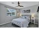 Comfortable bedroom with a ceiling fan, window overlooking the backyard, and neutral decor at 18132 E Vencino St, Gilbert, AZ 85298