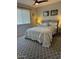 Comfortable bedroom featuring a decorative ceiling fan, a window, and a patterned rug at 18132 E Vencino St, Gilbert, AZ 85298