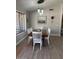 A dining room with a dark wood table, white chairs, and a pendant light fixture at 18132 E Vencino St, Gilbert, AZ 85298