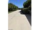 Long driveway flanked by lush landscaping and mature trees enhances the curb appeal of this property at 18132 E Vencino St, Gilbert, AZ 85298